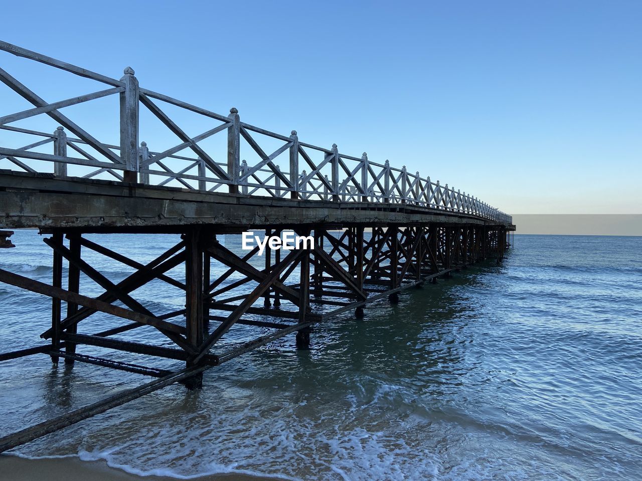 water, sea, sky, architecture, built structure, pier, nature, ocean, beach, blue, scenics - nature, land, bridge, clear sky, beauty in nature, coast, no people, shore, horizon, transportation, wave, travel destinations, outdoors, horizon over water, tranquility, environment, reflection, day, travel, tranquil scene, idyllic, seascape, coastline, tourism, motion