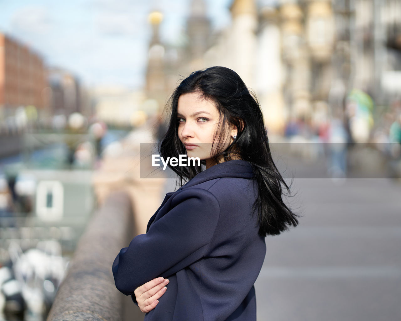 Portrait of woman standing on street in city