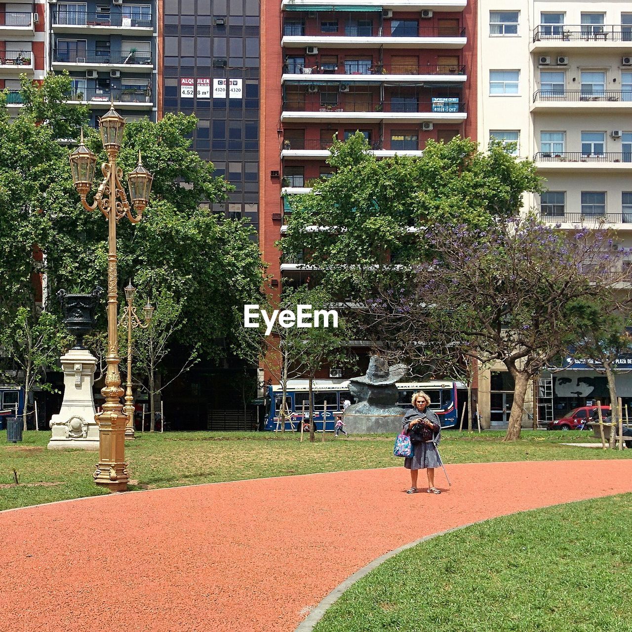 REAR VIEW OF WOMAN WALKING IN PARK