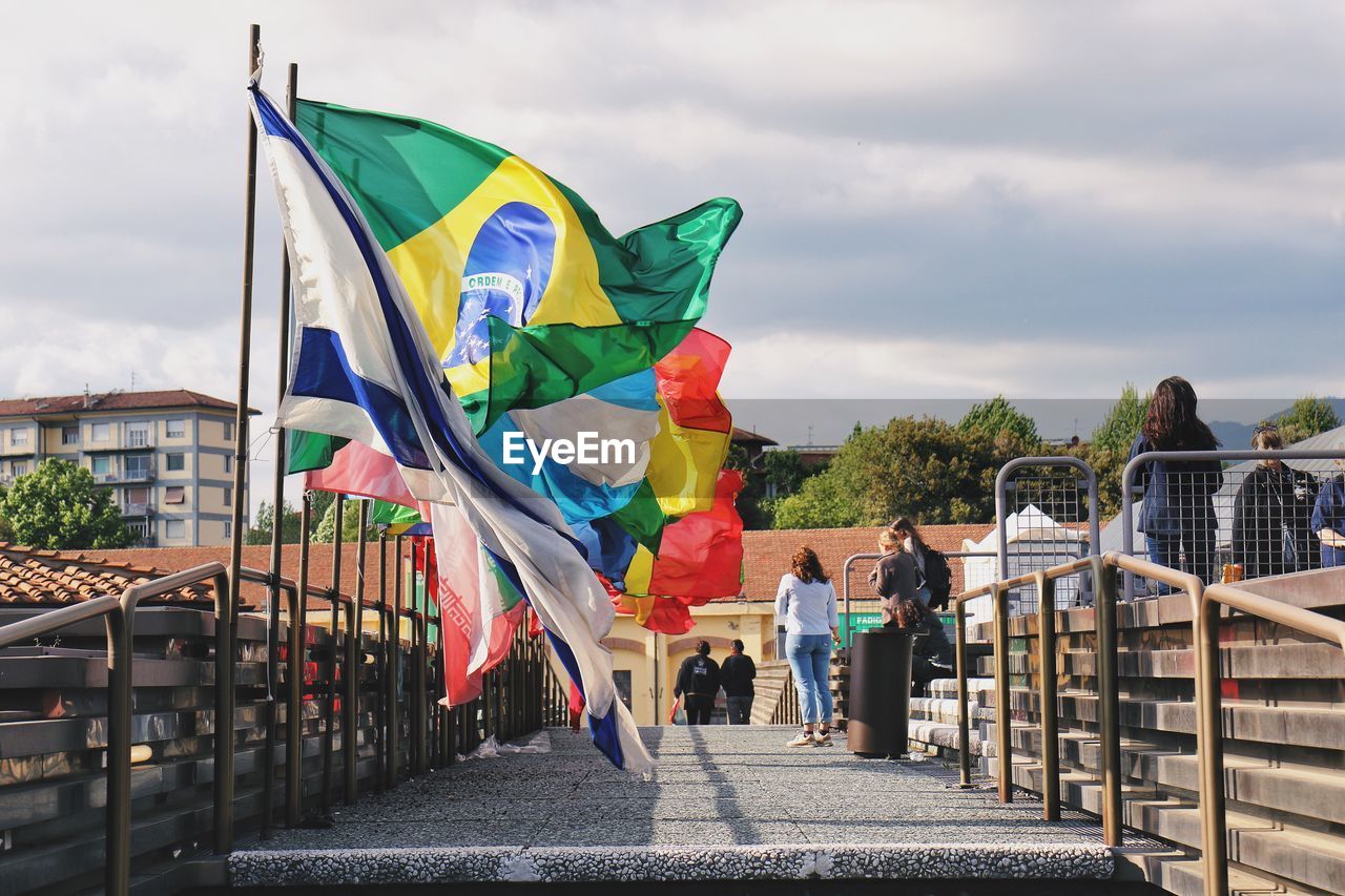 FLAG BY RAILING AGAINST SKY