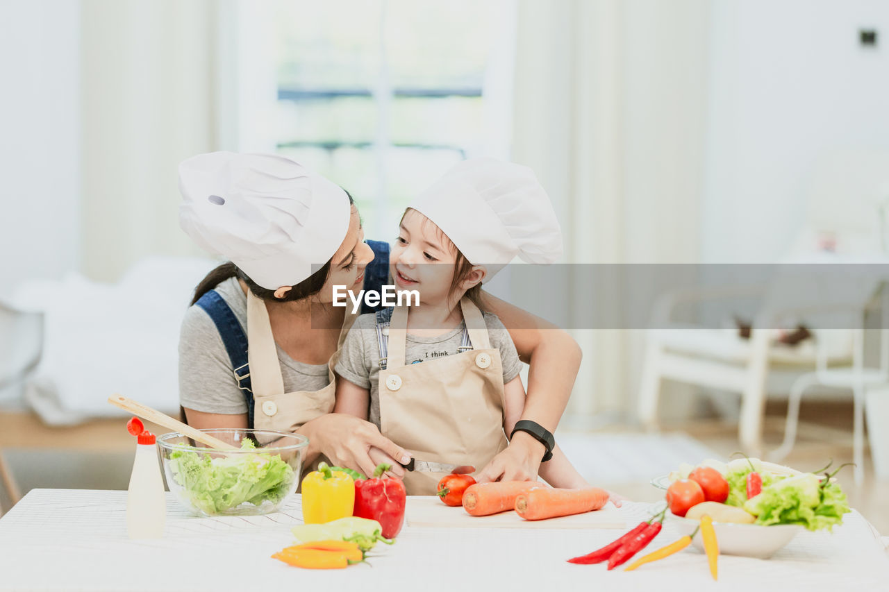 MIDSECTION OF WOMAN PREPARING FOOD
