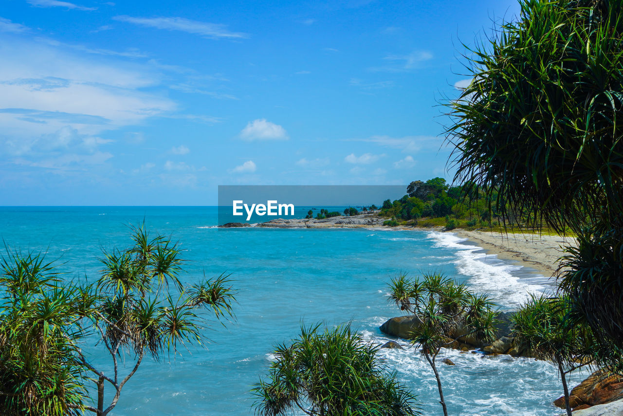 water, sea, sky, land, beach, tropical climate, tree, beauty in nature, scenics - nature, plant, nature, palm tree, travel destinations, tranquility, body of water, ocean, travel, vacation, blue, horizon over water, tranquil scene, tropics, trip, holiday, shore, cloud, tourism, horizon, sand, island, coast, idyllic, coastline, environment, coconut palm tree, bay, no people, outdoors, tropical tree, day, seascape, lagoon, relaxation, landscape, tourist resort, water's edge, summer, sunlight, turquoise colored, bay of water, non-urban scene, urban skyline, nautical vessel