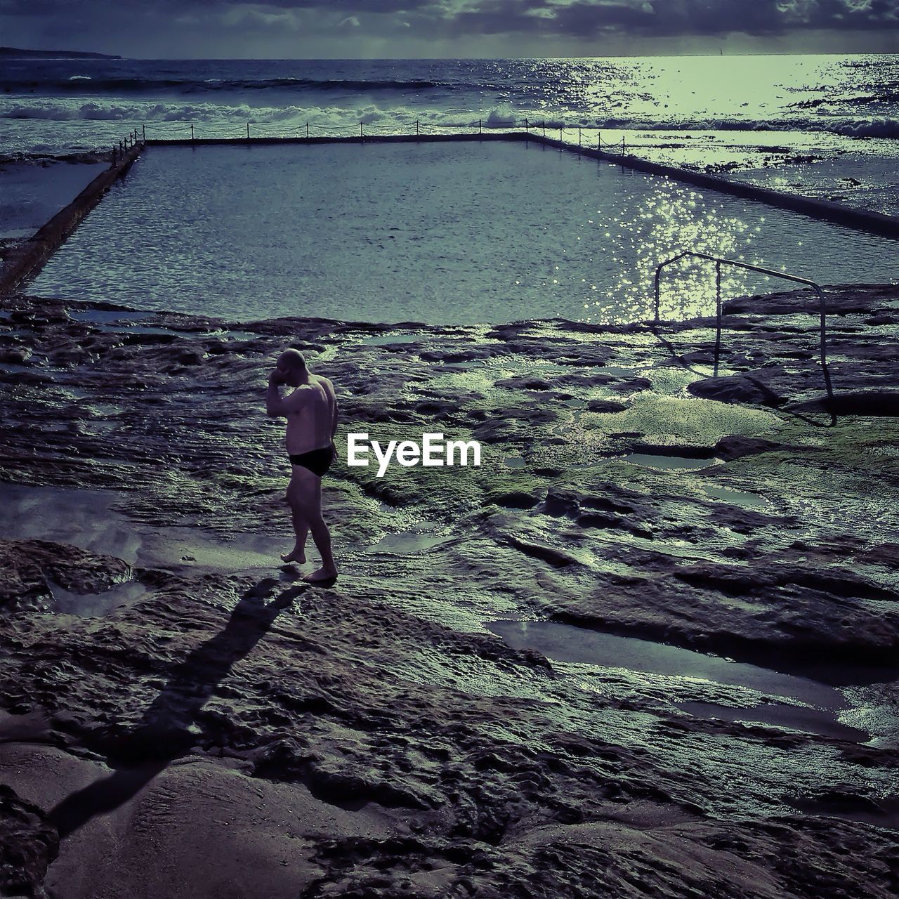 WOMAN STANDING ON BEACH