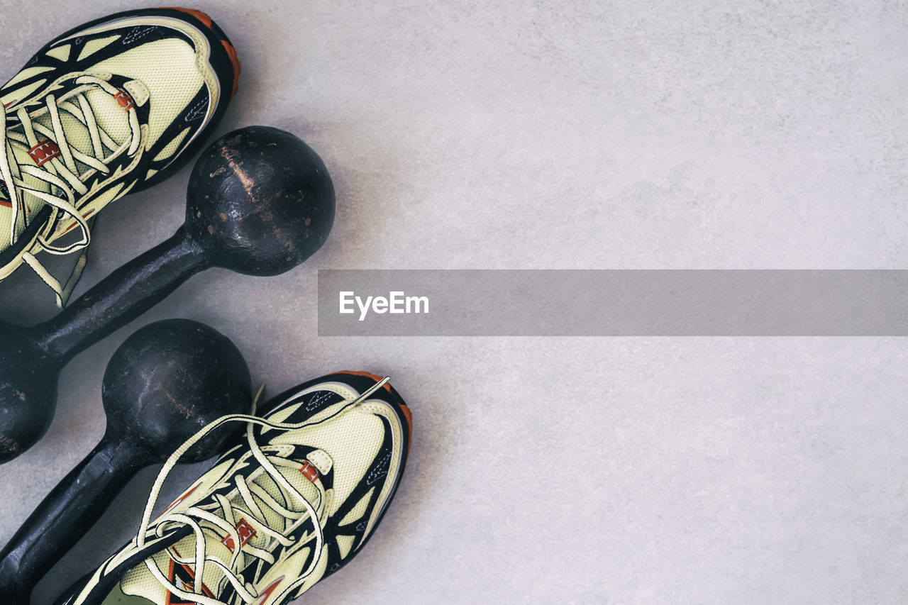 High angle view of shoes and dumbbells on floor