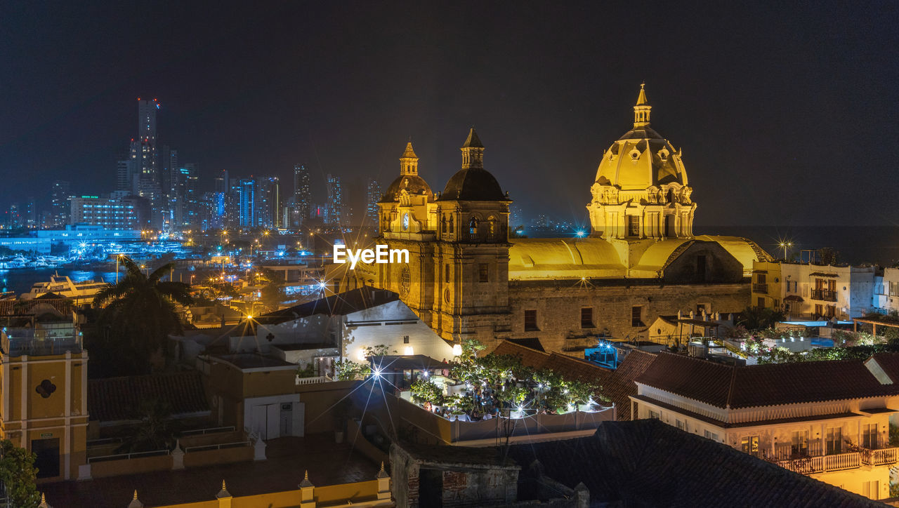 Illuminated buildings in city at night