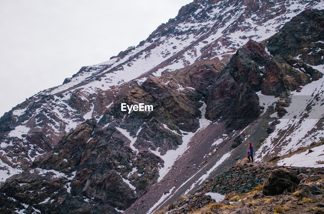 Full length of woman standing against mountain