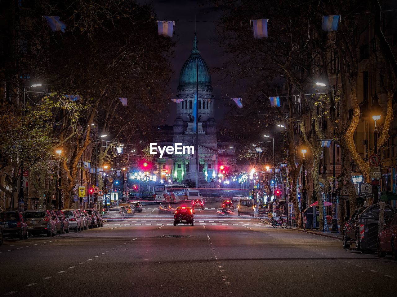 Car on road at avenida de mayo in city during night