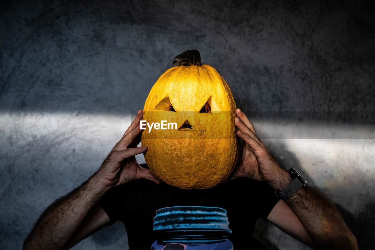 rear view of woman with pumpkin