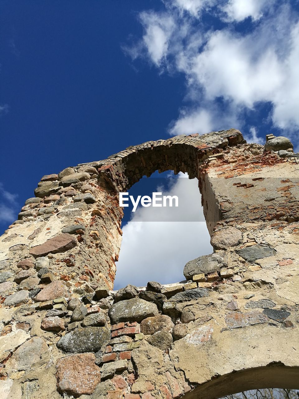 Low angle view of rock formation against sky