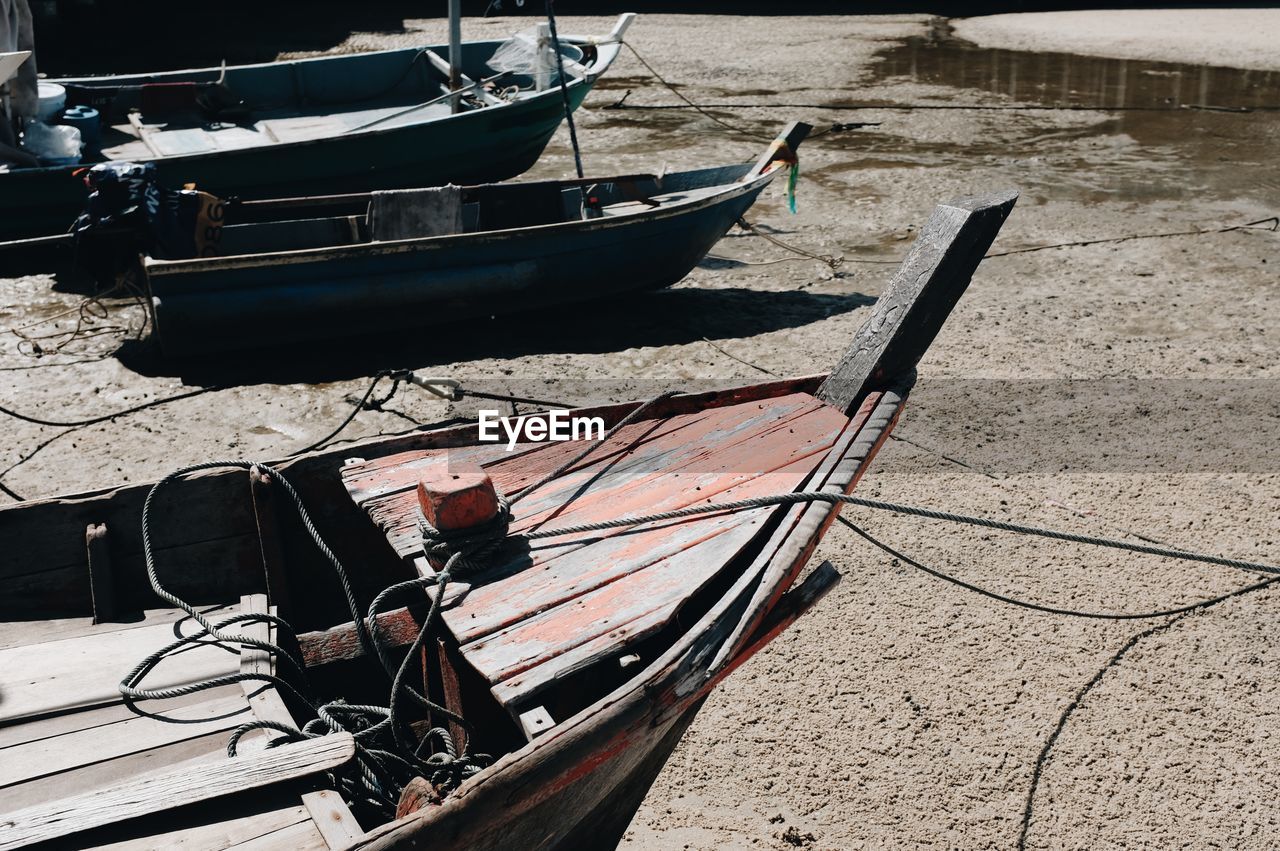 HIGH ANGLE VIEW OF FISHING BOATS MOORED ON SHORE