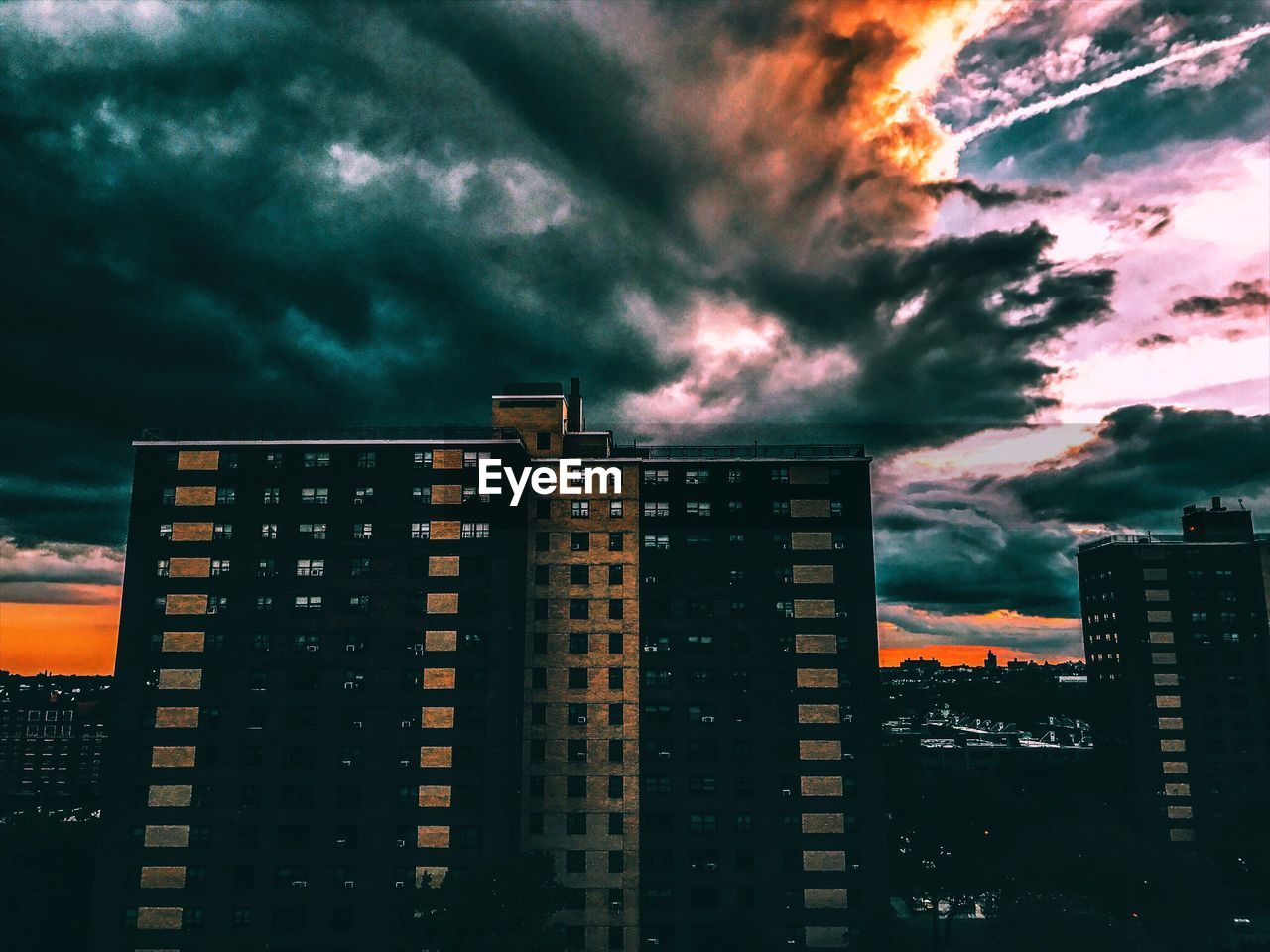 VIEW OF CITY AGAINST CLOUDY SKY