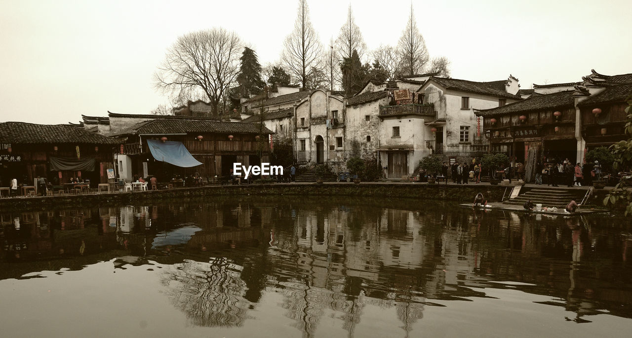 REFLECTION OF BUILDINGS ON LAKE