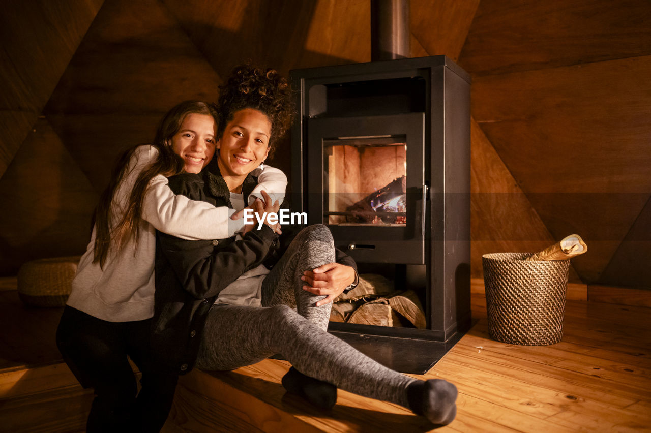 Happy lesbian couple smiling while enjoying indoors.