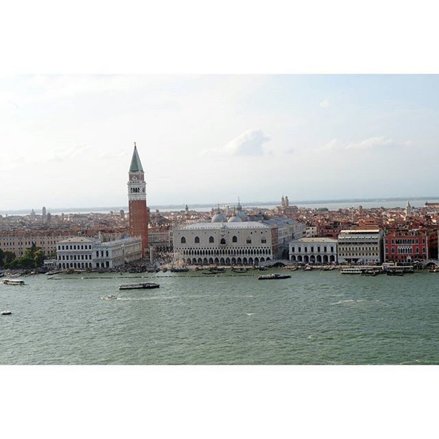 VIEW OF RIVER WITH BUILDINGS IN BACKGROUND