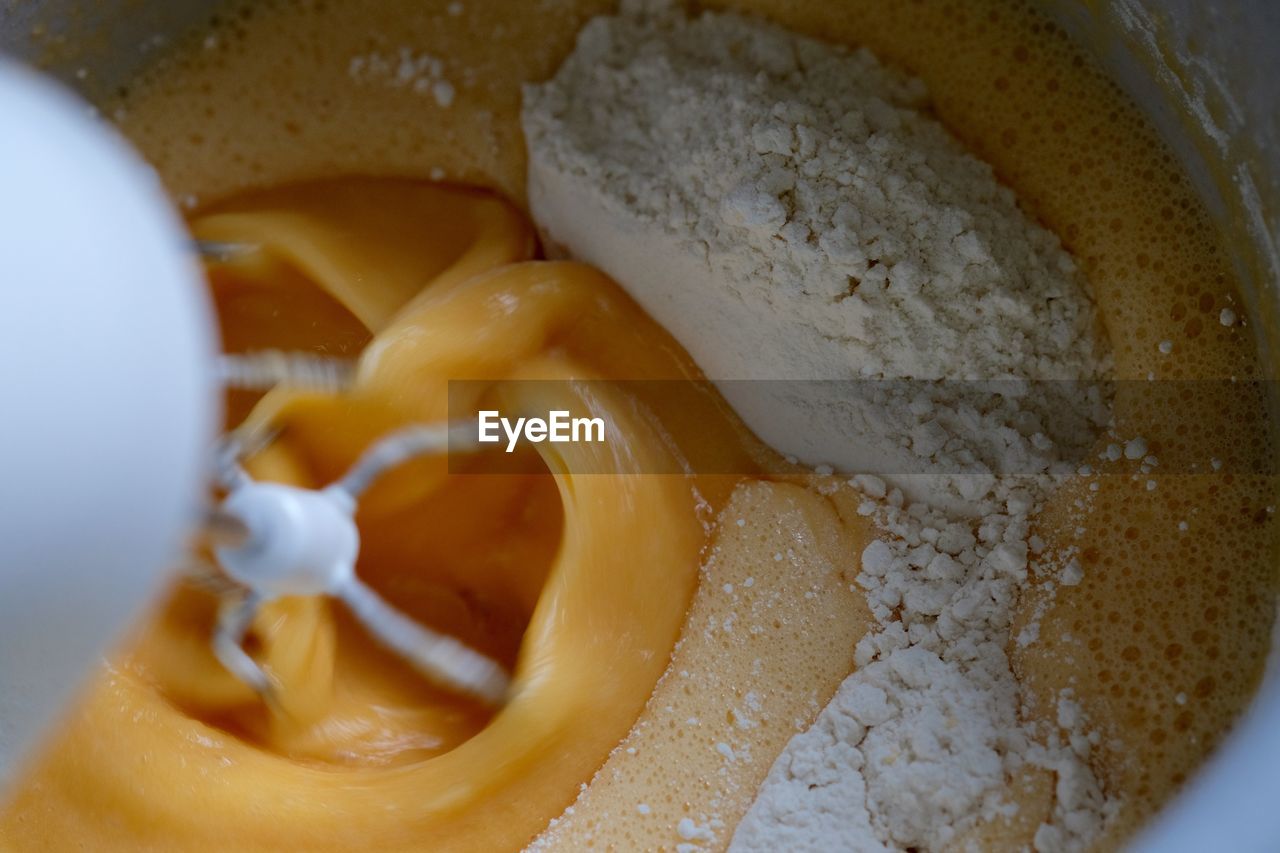 Cropped image of electric beater mixing batter