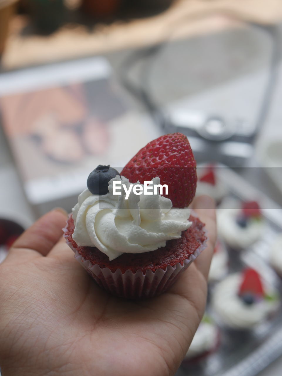 food, food and drink, hand, sweet food, sweet, dessert, holding, freshness, one person, berry, fruit, sweetness, cake, strawberry, close-up, indoors, adult, temptation, flower, icing, ice cream, focus on foreground, baked, healthy eating, selective focus, frozen food, dairy, lifestyles, cream, red, cupcake