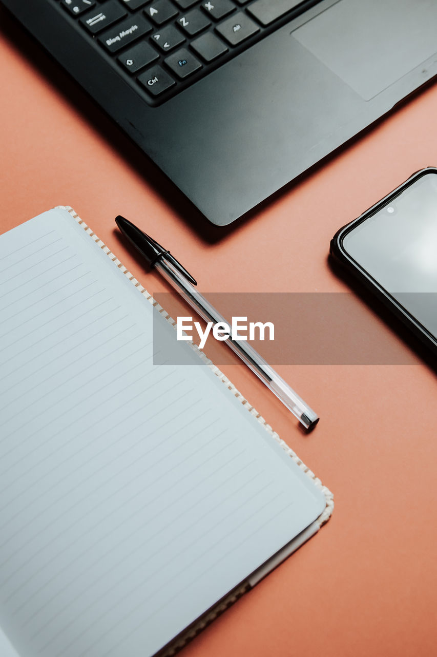 high angle view of pen and book on table