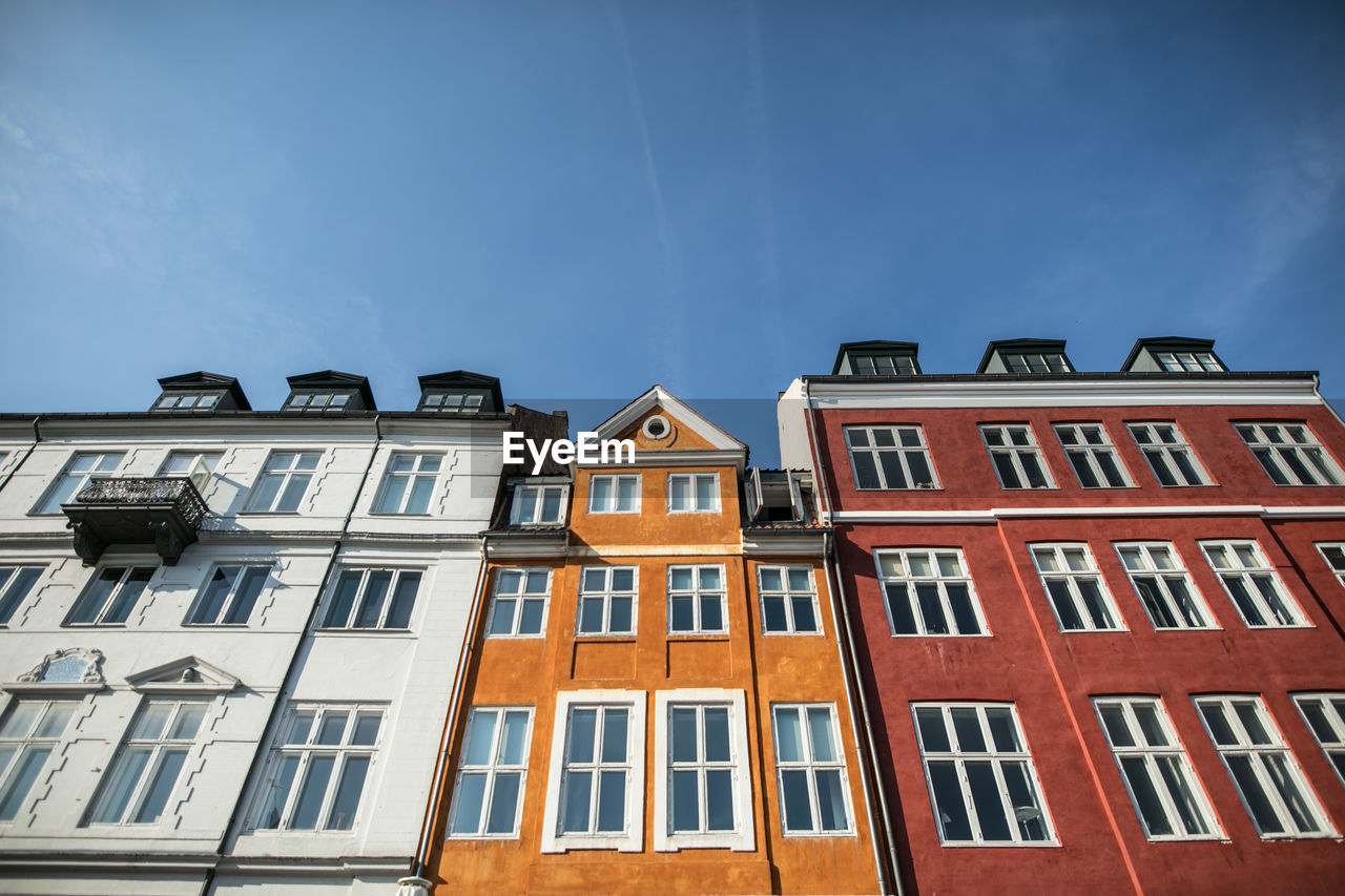 Low angle view of residential buildings against blue sky