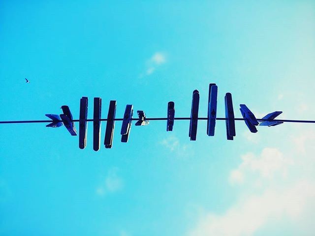 LOW ANGLE VIEW OF CABLES AGAINST BLUE SKY