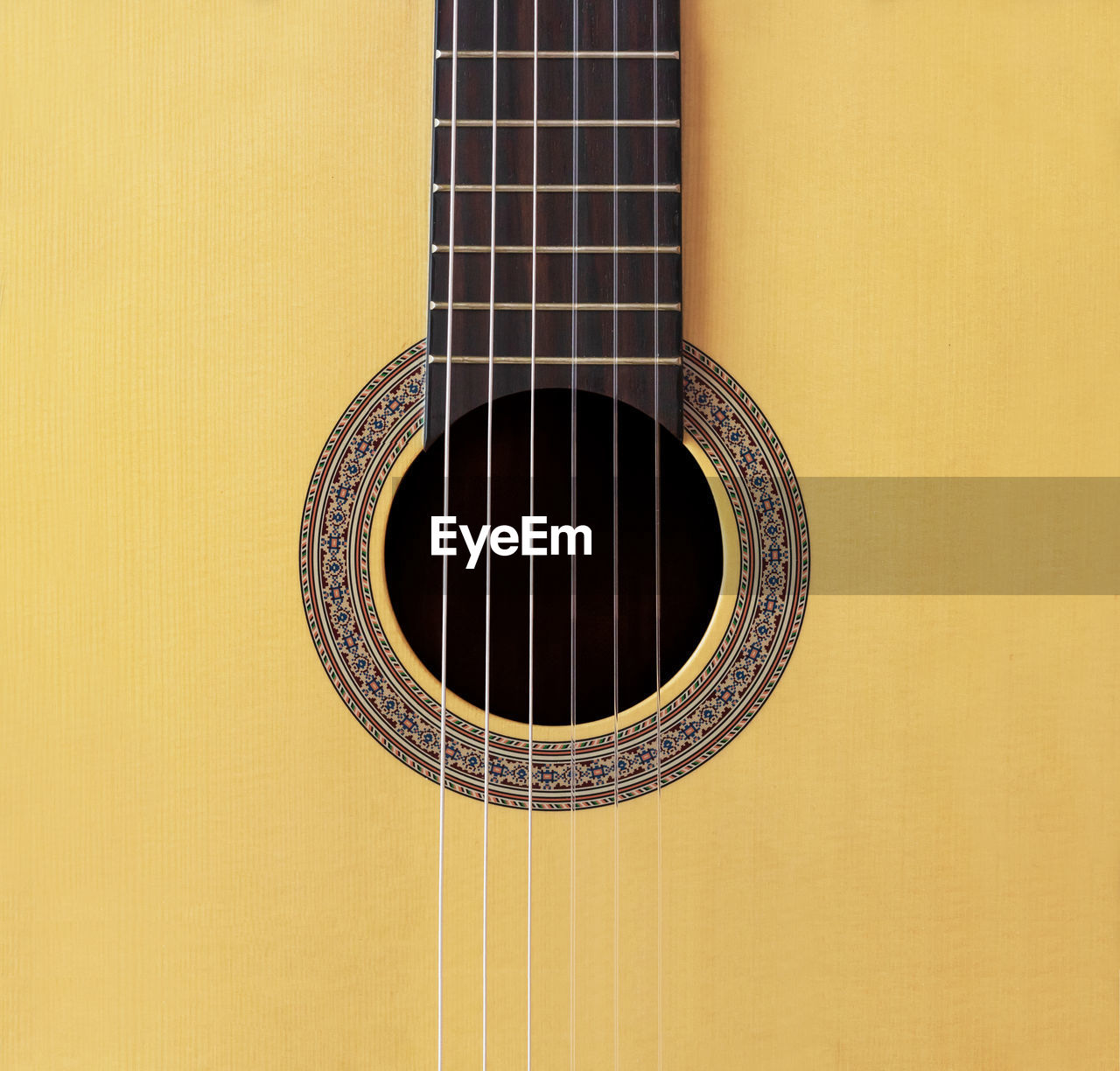 Close-up of guitar against yellow background