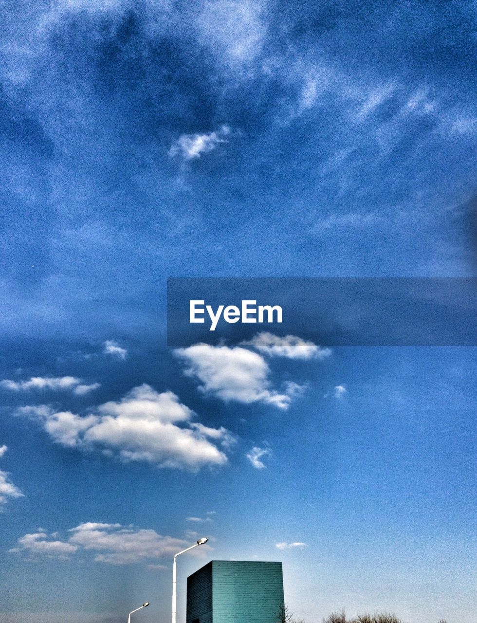 LOW ANGLE VIEW OF BUILDING AGAINST BLUE SKY