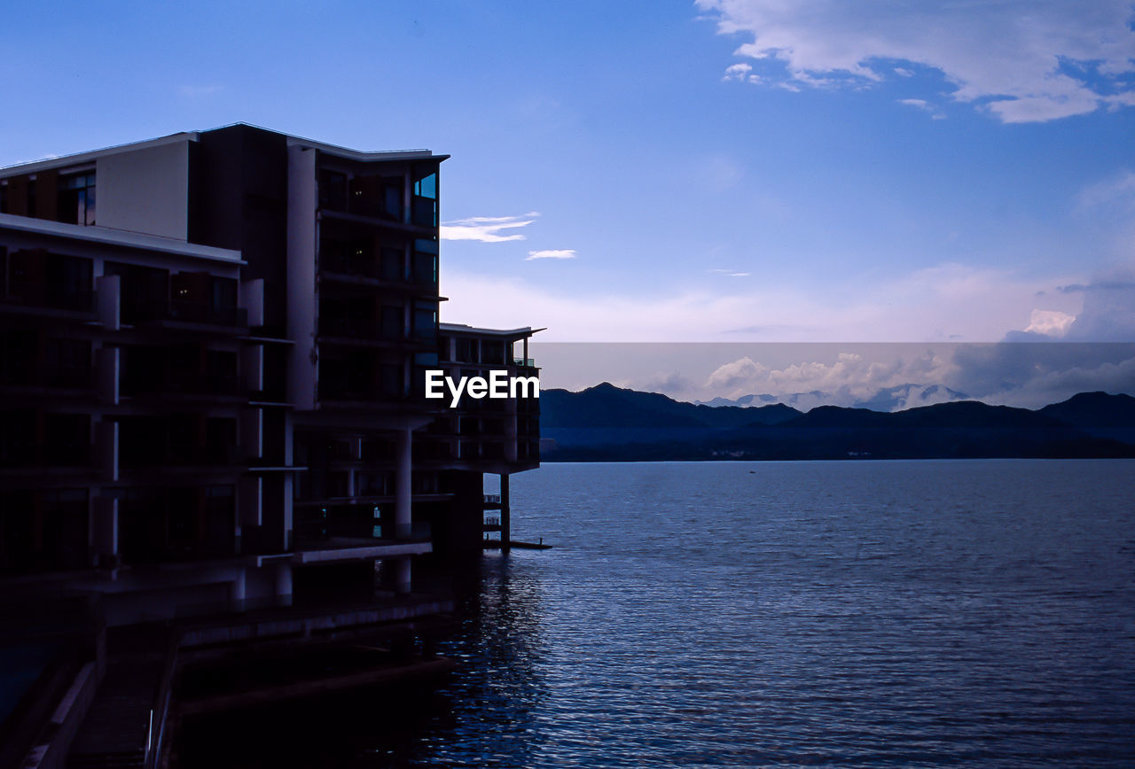 BUILDING BY SEA AGAINST SKY