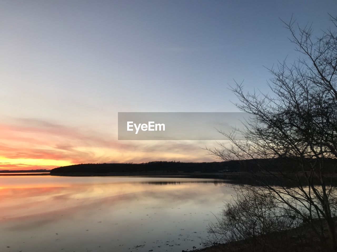 SCENIC VIEW OF SUNSET OVER LAKE