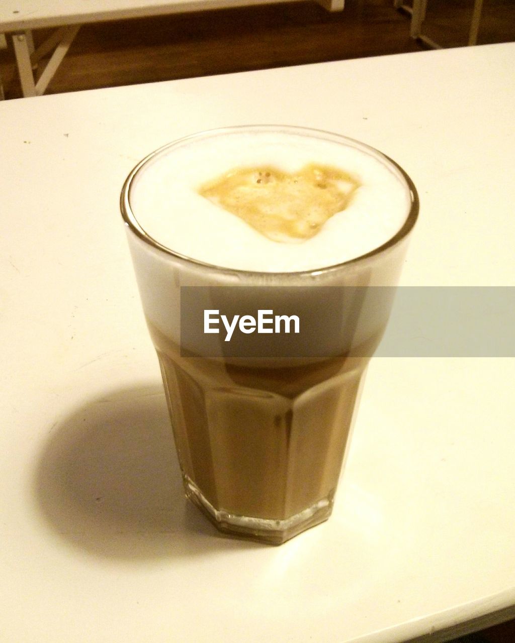 Close-up of coffee glass on table