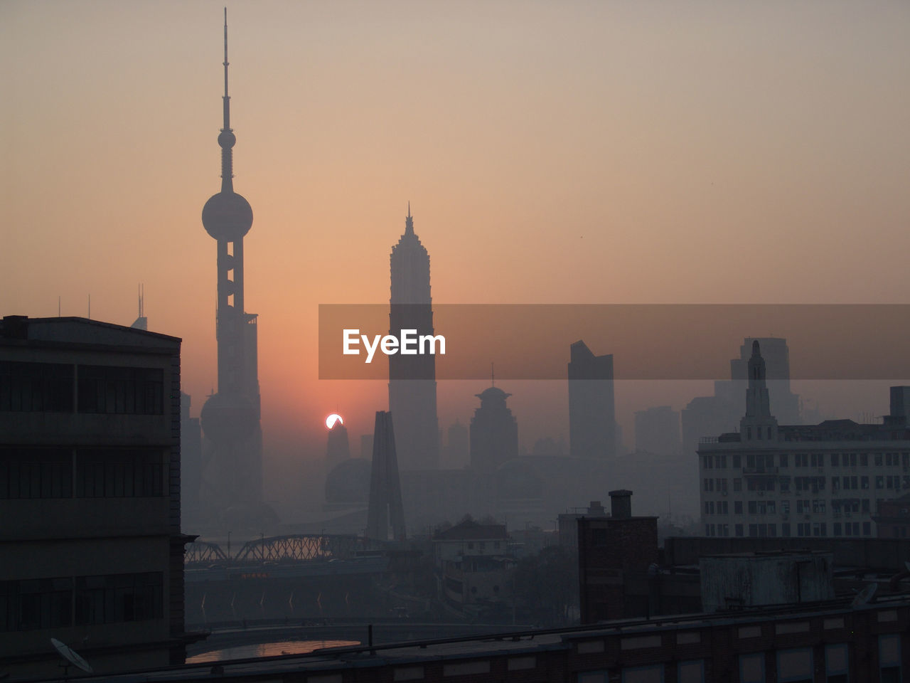 Buildings in city during sunset