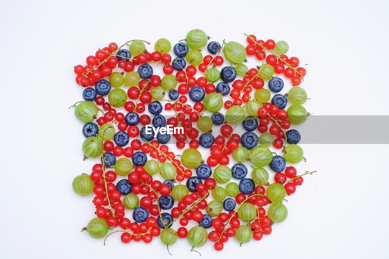 CLOSE-UP OF BERRIES OVER WHITE BACKGROUND