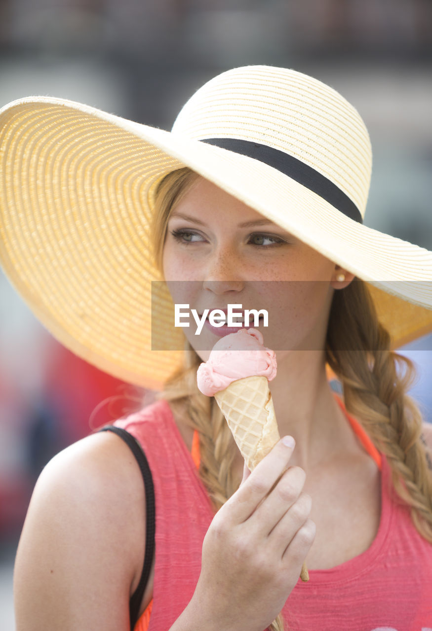 Woman looking away while having ice cream