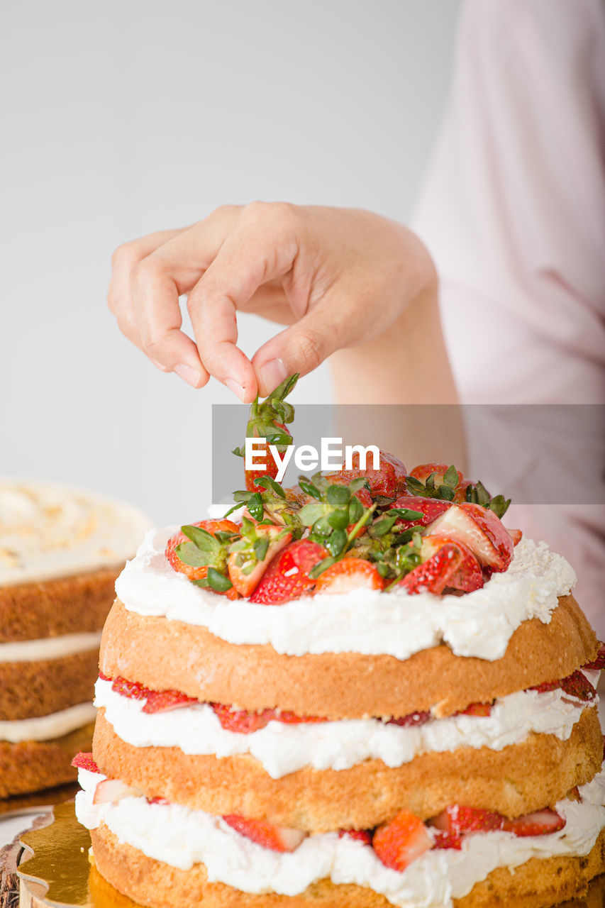 midsection of woman holding cake