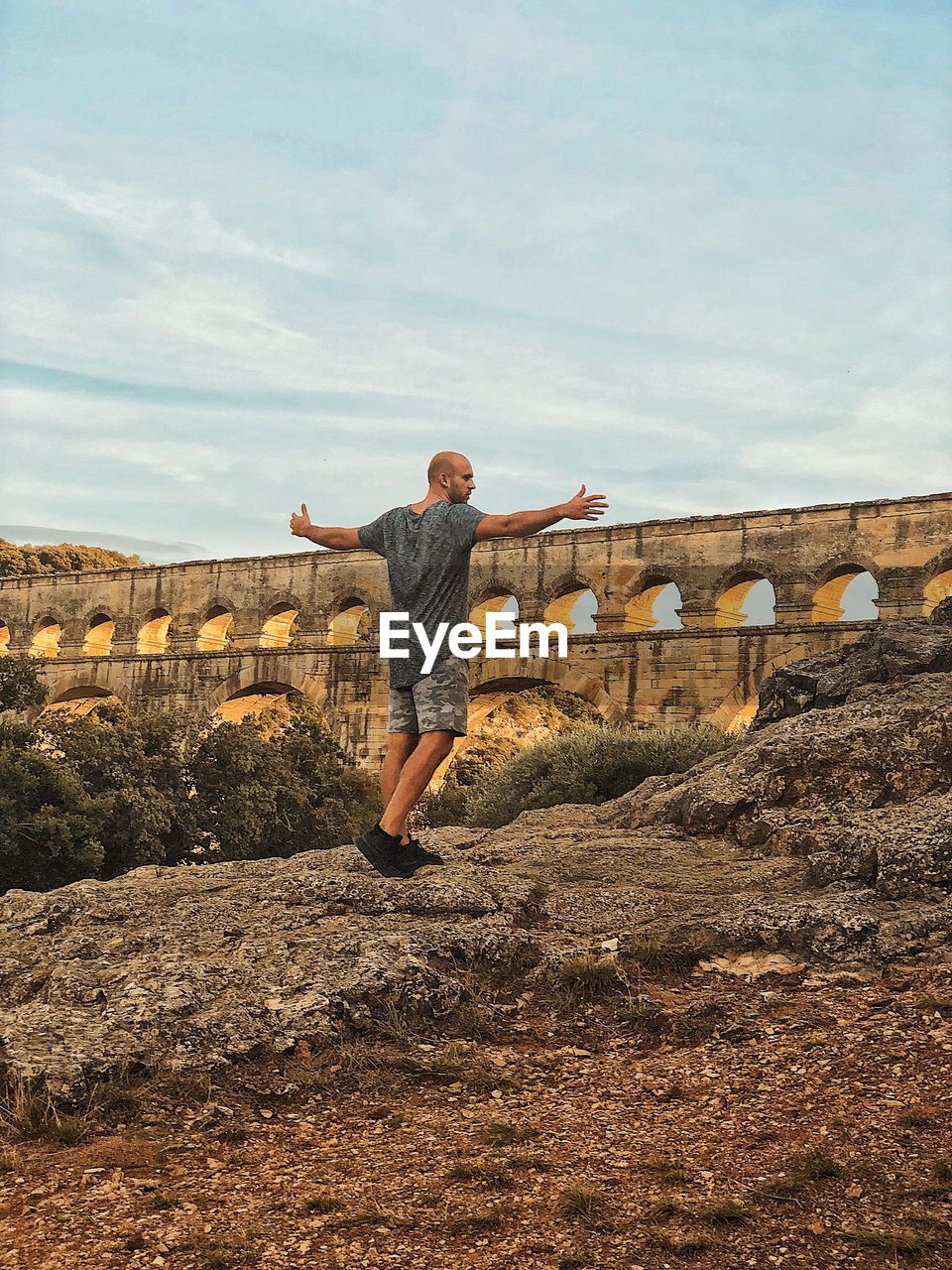 Full length of man standing on mountain against wall