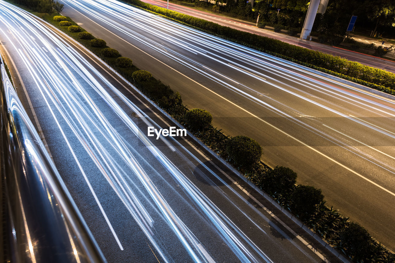HIGH ANGLE VIEW OF LIGHT TRAILS ON HIGHWAY BY STREET