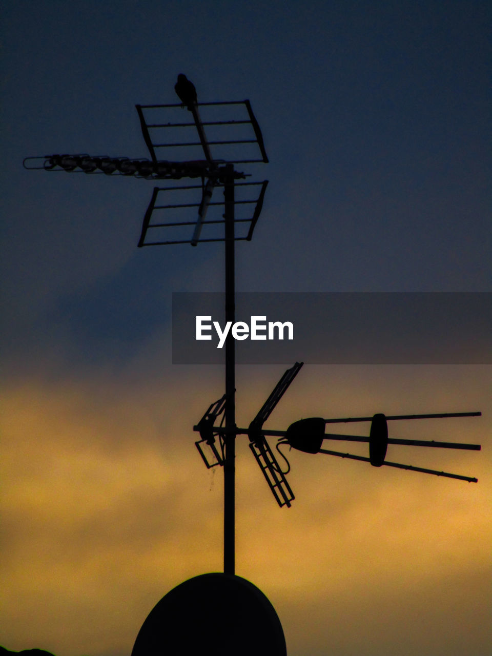 LOW ANGLE VIEW OF WEATHER VANE AGAINST CLOUDY SKY