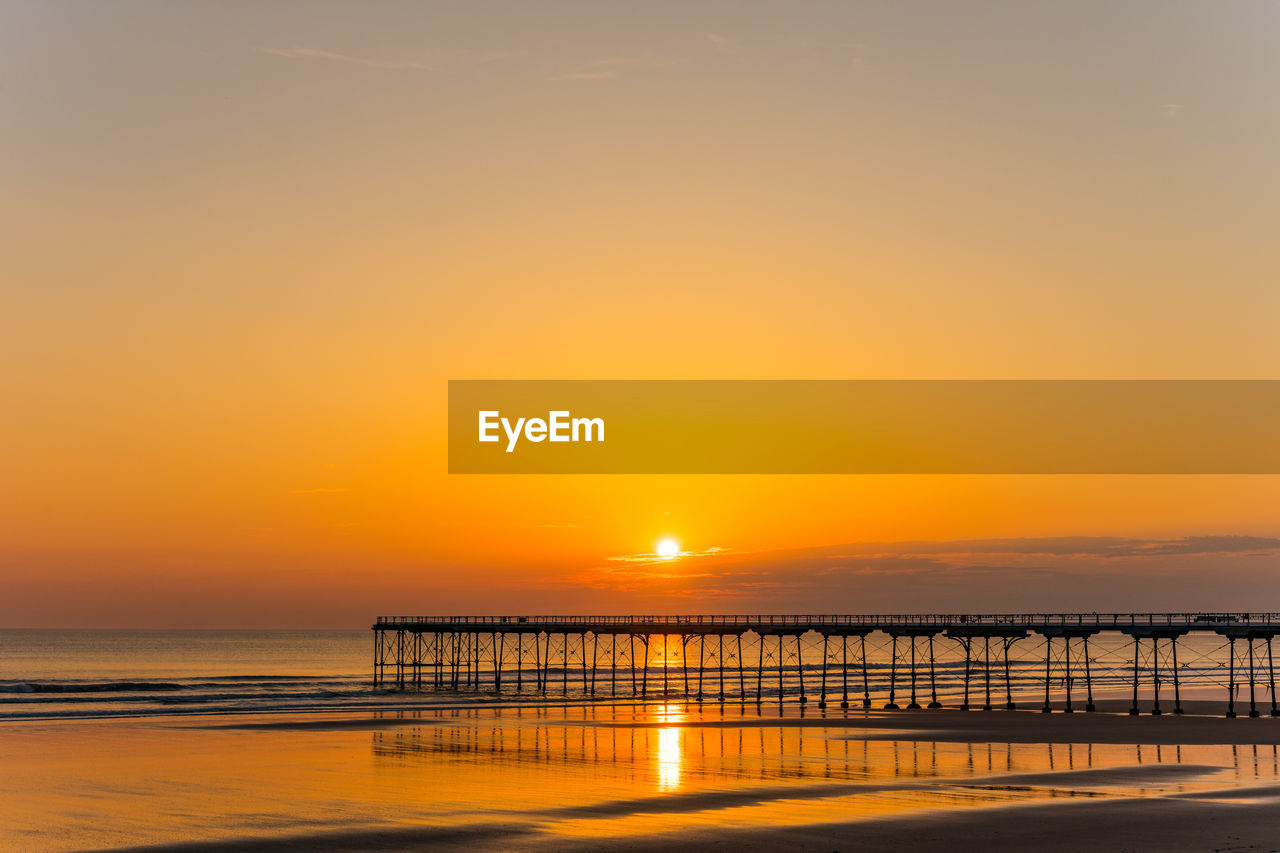 SCENIC VIEW OF SUNSET OVER SEA