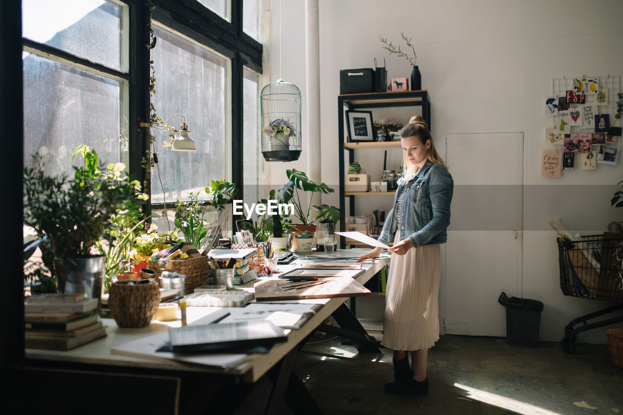 Woman working at desk in workshop