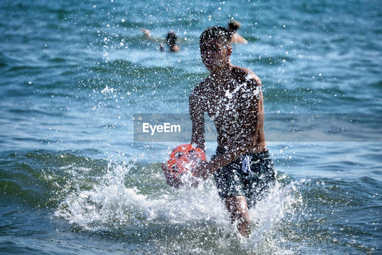 Man splashing water in sea