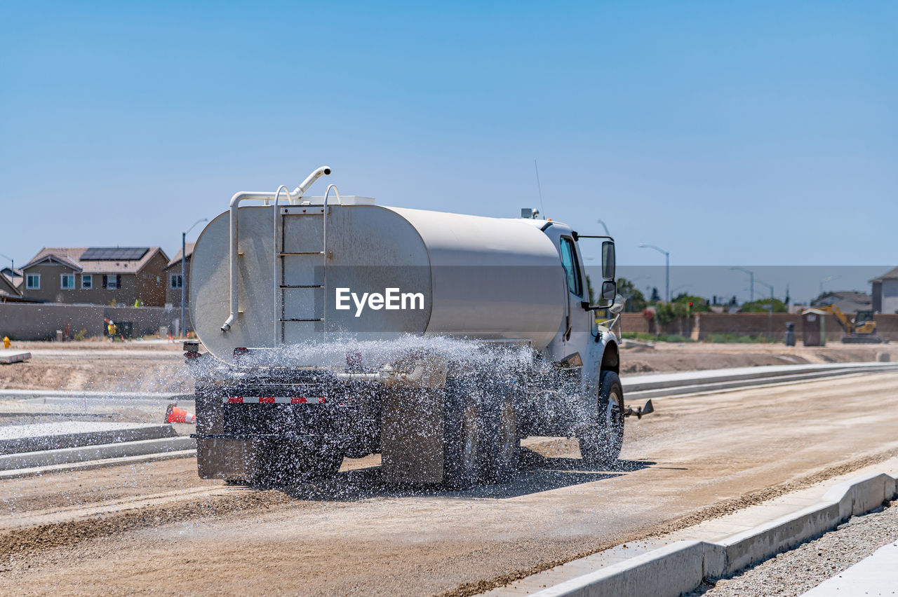 The watering machine waters the road. road construction. repair.