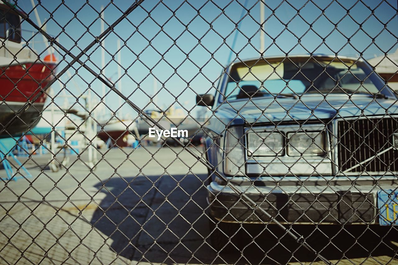 Chain link fence with car behind