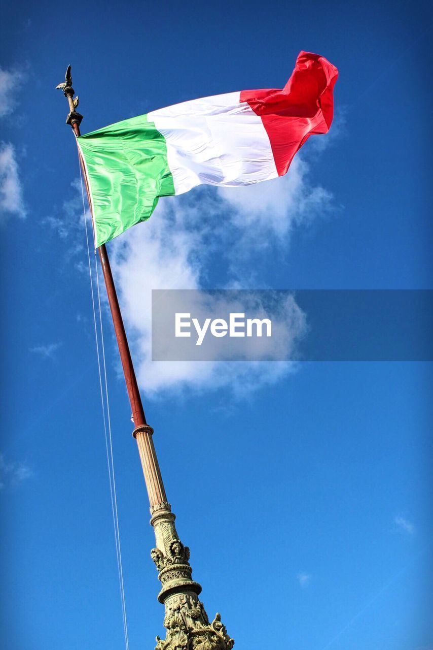 LOW ANGLE VIEW OF FLAG ON BLUE SKY