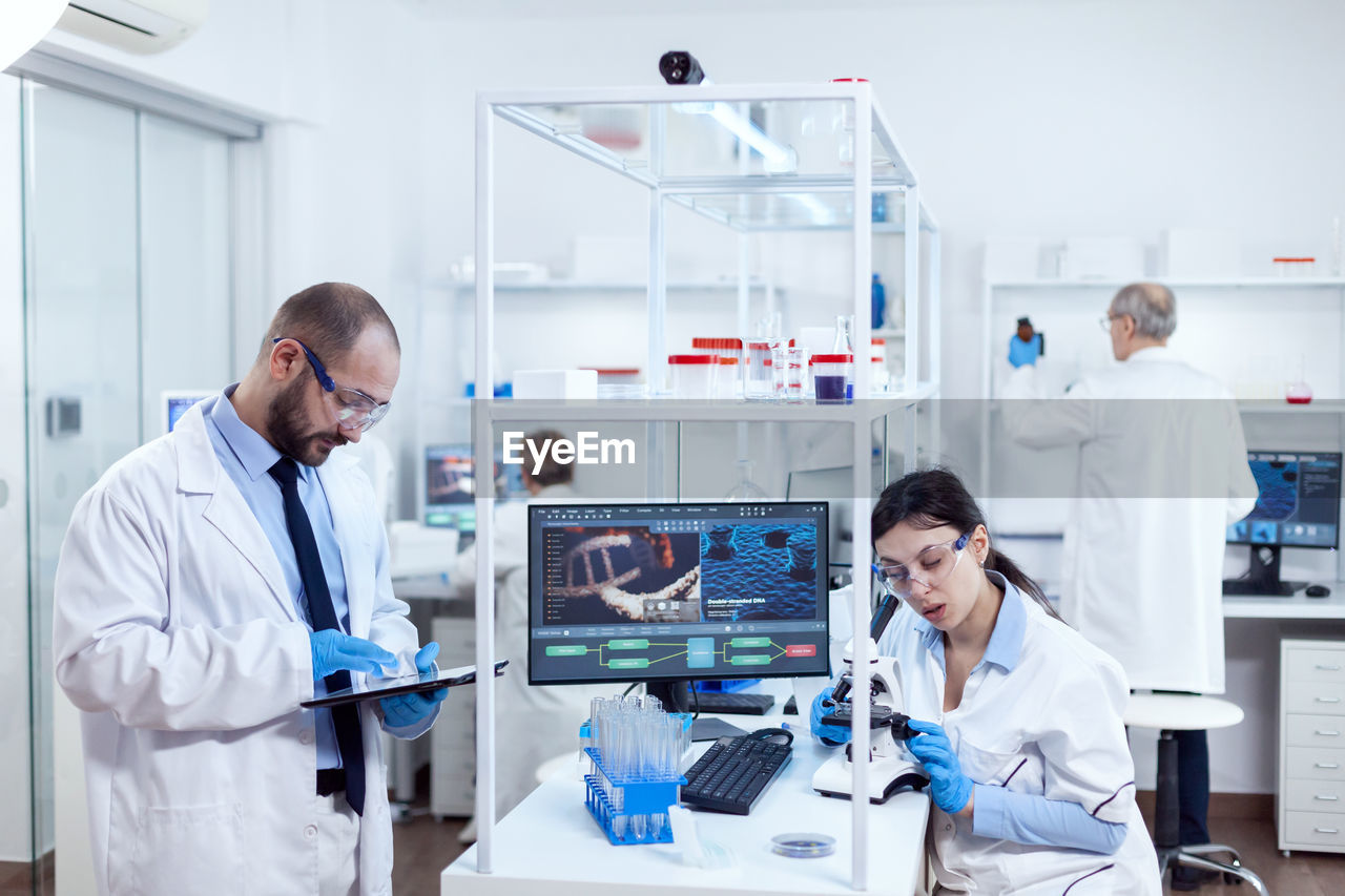 female doctor examining chemical in laboratory