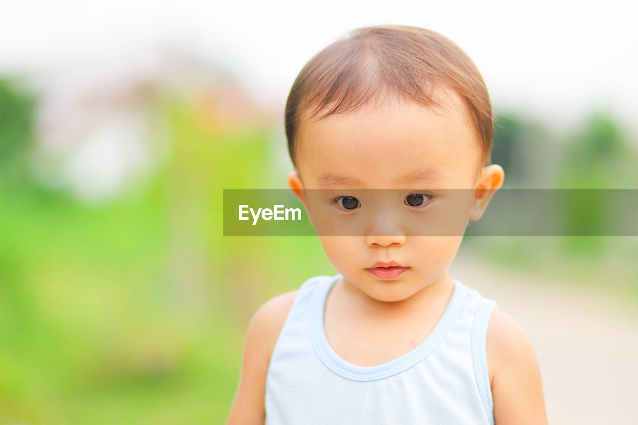 Close-up of cute baby boy looking down