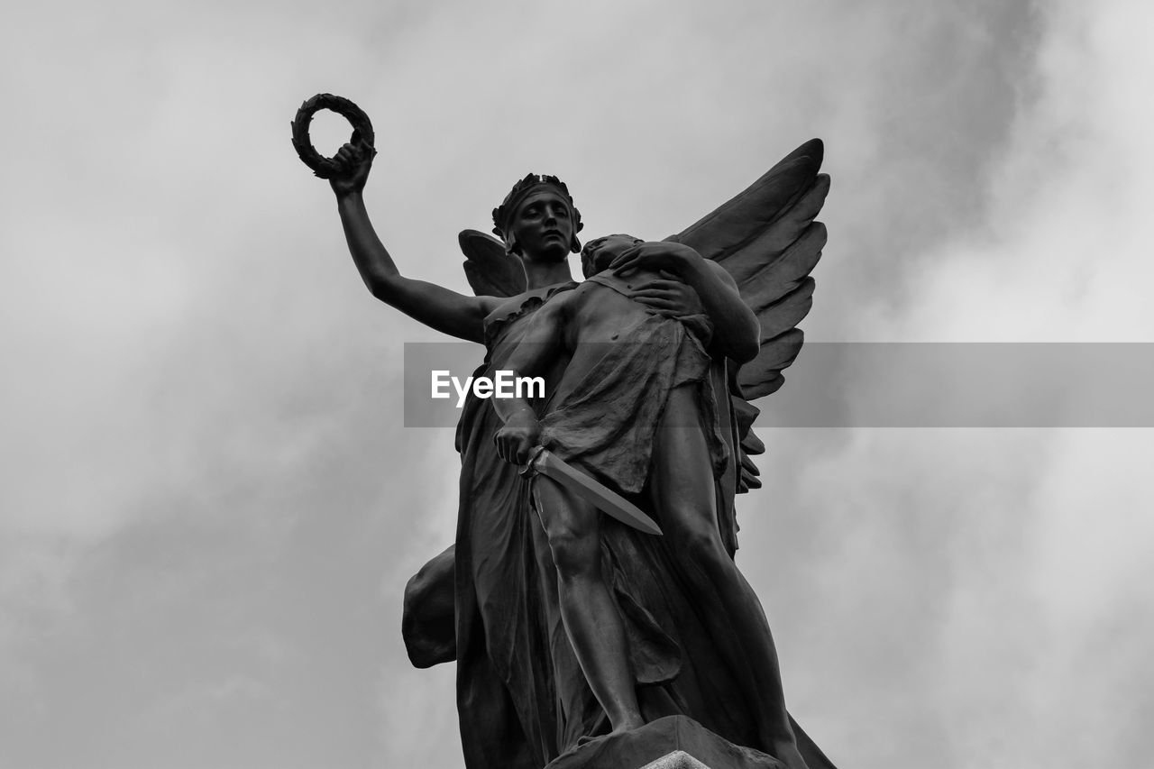 Low angle view of statue against cloudy sky