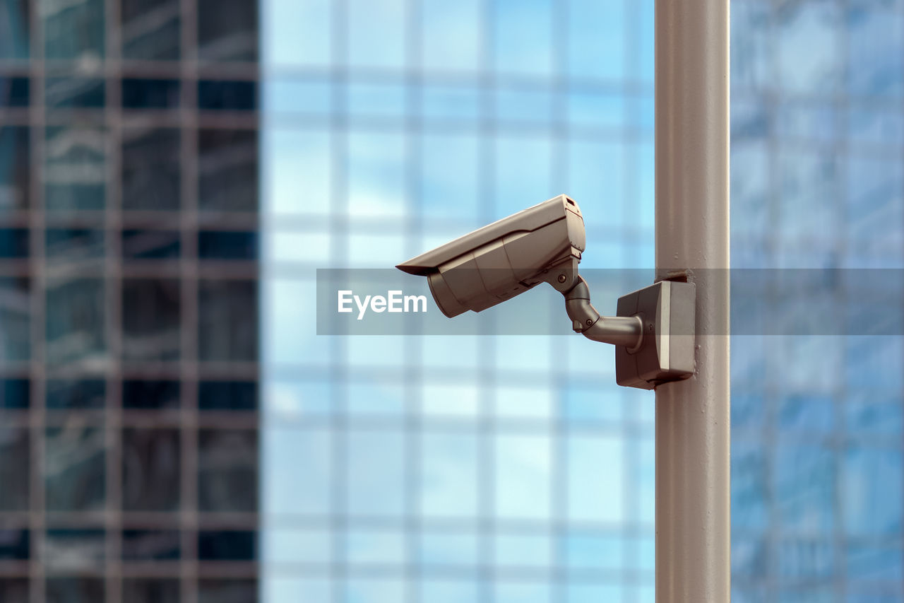 Security camera against glass building wall