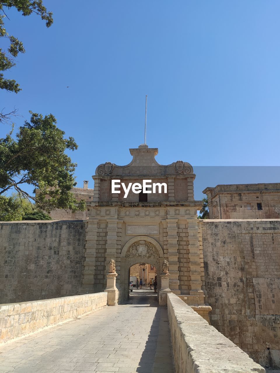 Low angle view of old building against clear blue sky