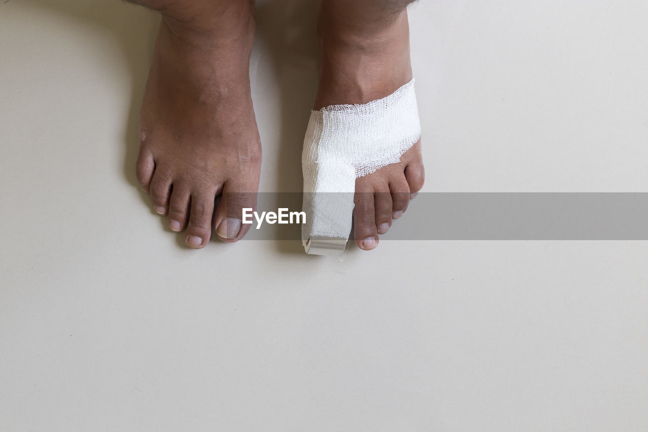 finger, hand, indoors, one person, adult, human leg, studio shot, low section, limb, barefoot, copy space, human limb, toe, human foot, white, nail, close-up, men