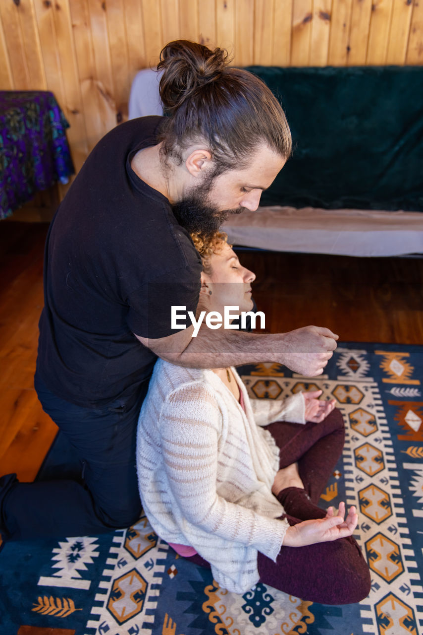 high angle view of mother and daughter on bed at home