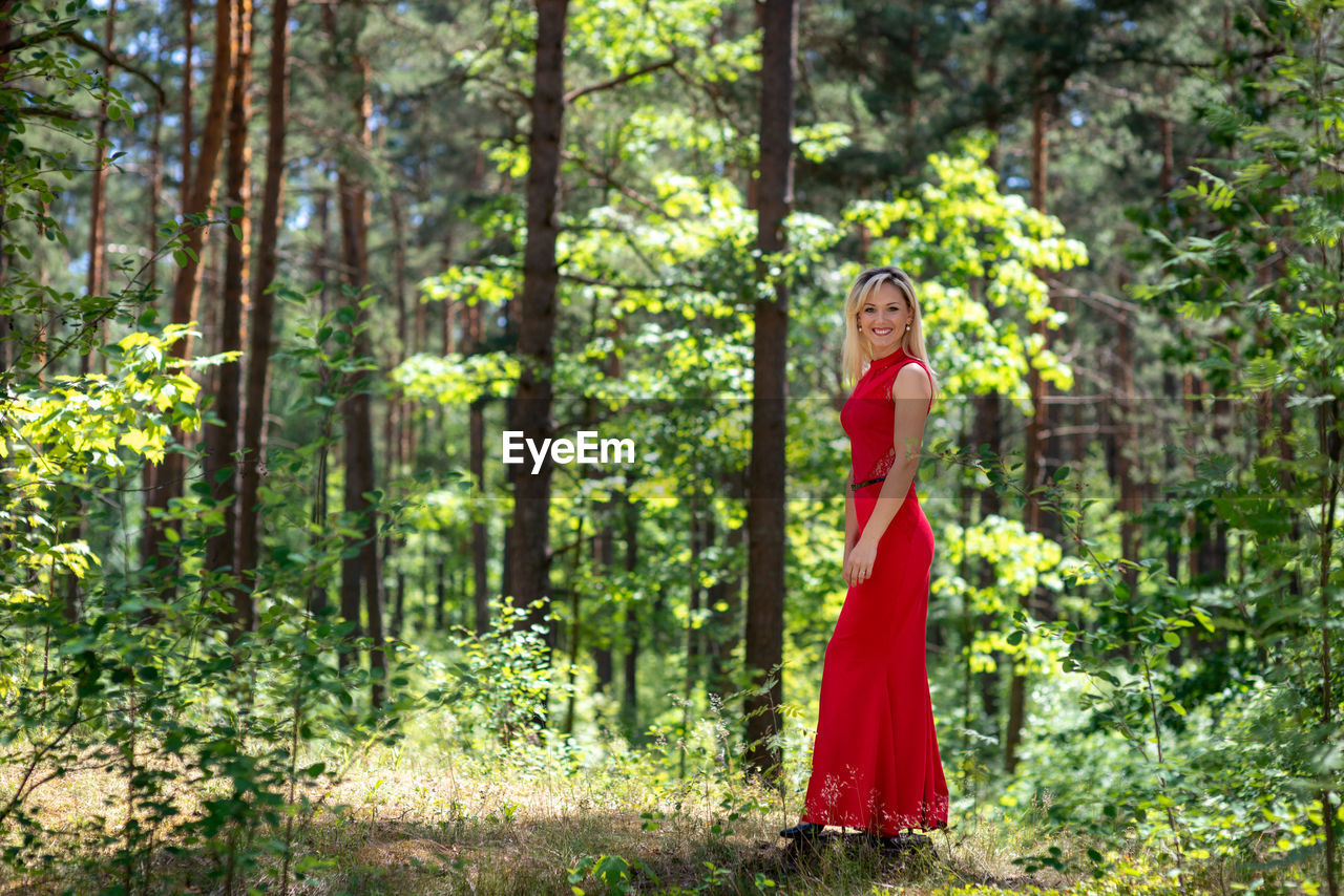 Portrait of woman standing in forest