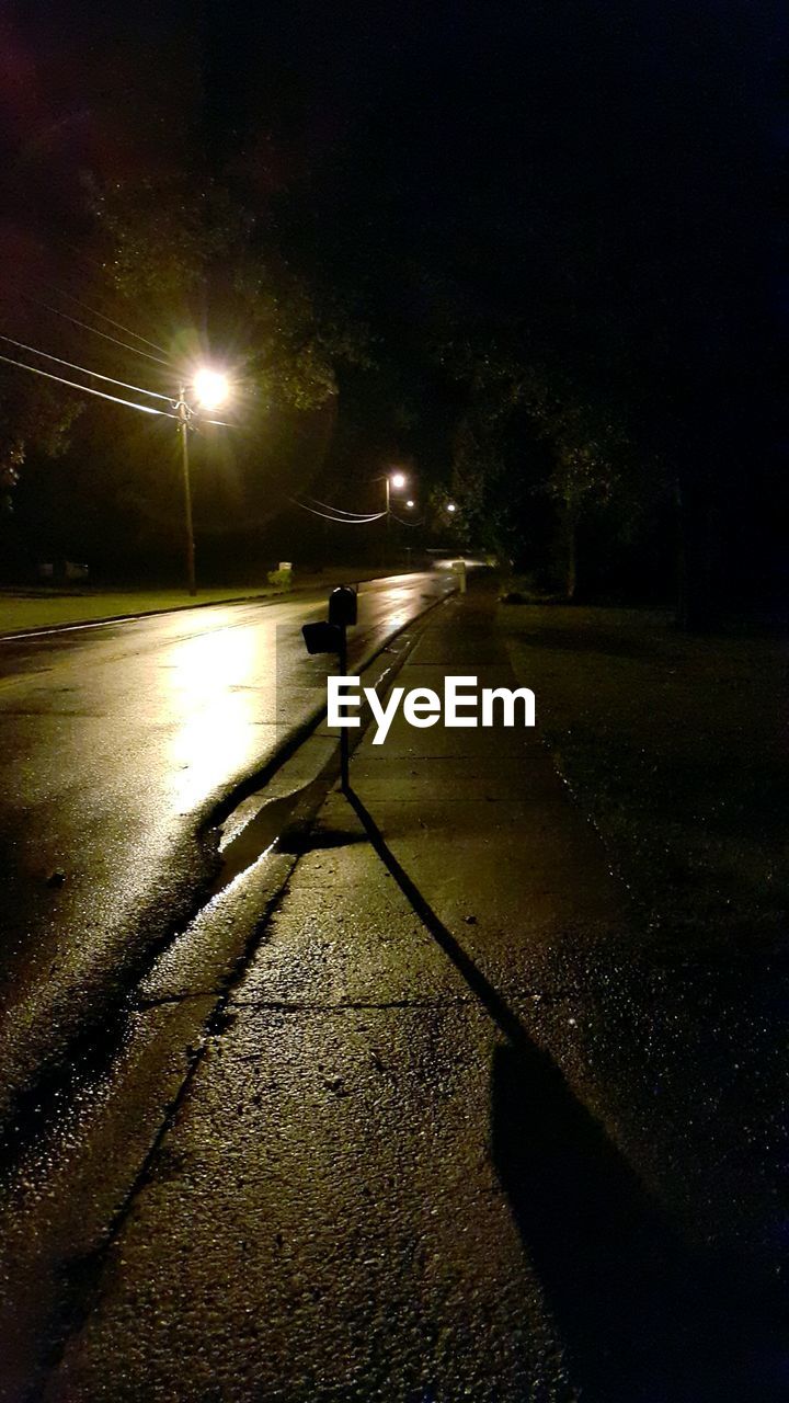 VIEW OF ILLUMINATED STREET LIGHTS AT NIGHT